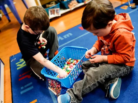 two boys playing with a toy