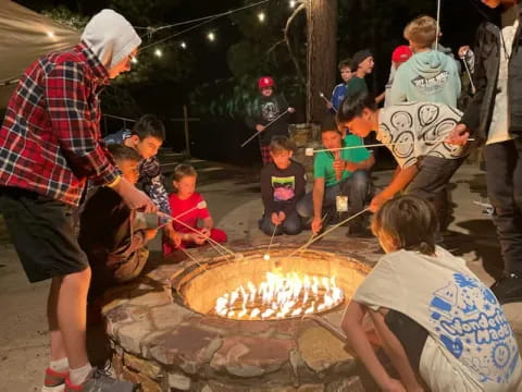 a group of people around a fire