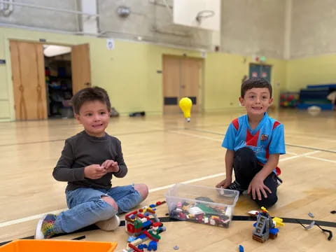 two boys sitting on the floor