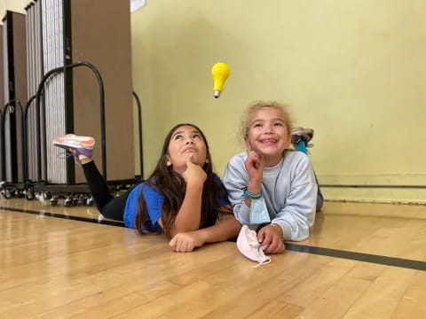 two women sitting on the floor