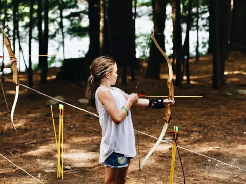 a girl shooting a bow and arrow