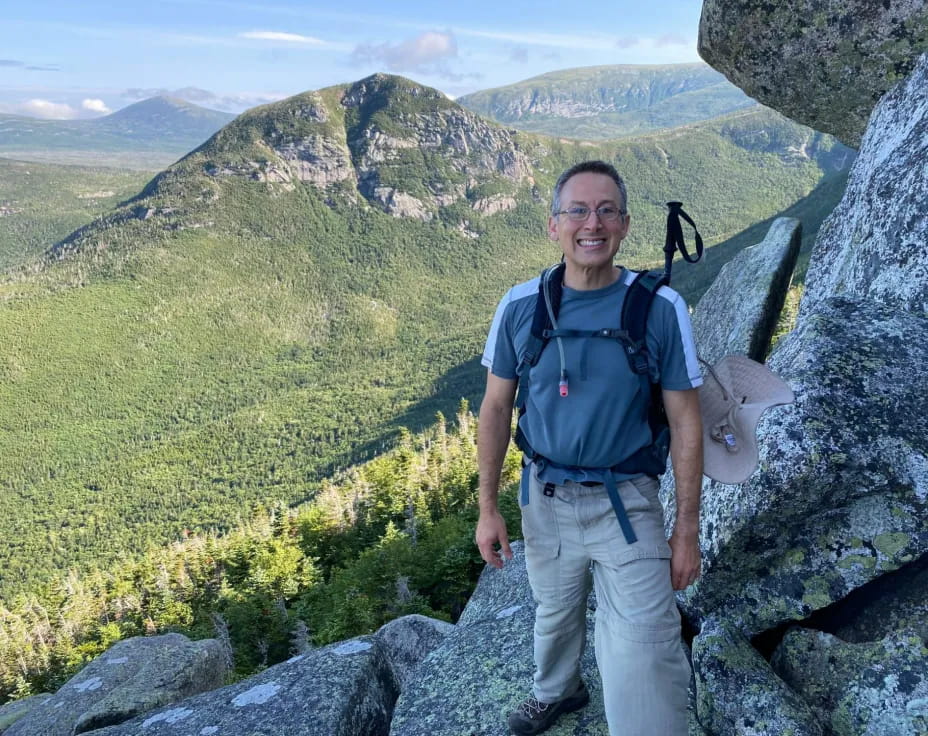 a man standing on a rocky hill