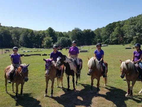 a group of people riding horses