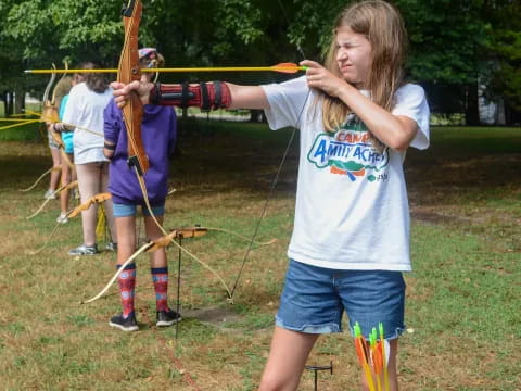 a girl holding a bow and arrow