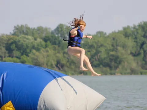 a girl jumping on a trampoline