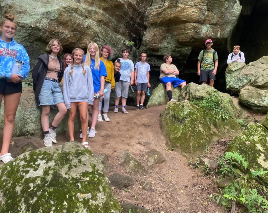 a group of people standing on rocks