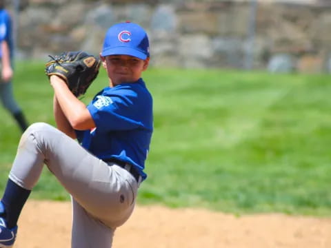 a young boy pitching a baseball
