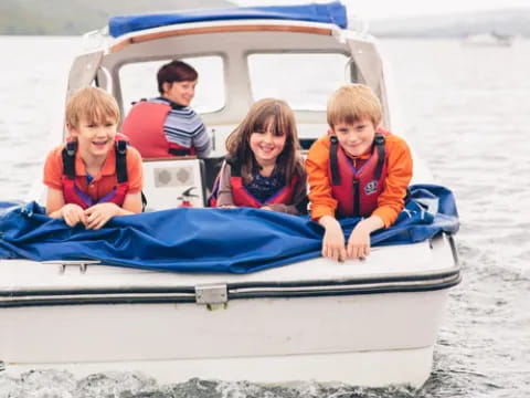 a group of kids in a boat