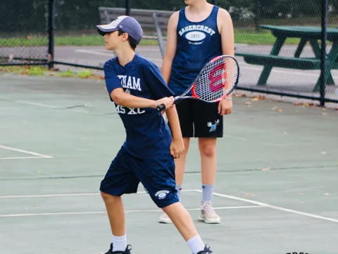 a couple of boys playing tennis