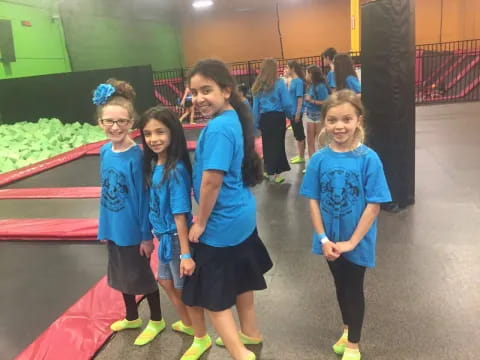 a group of girls in blue shirts