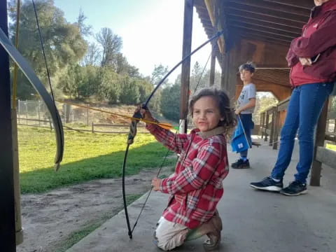 a girl holding a bow and arrow