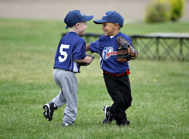 a couple of young boys playing baseball