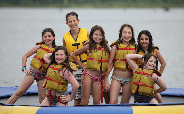a group of women in swimsuits posing for a photo