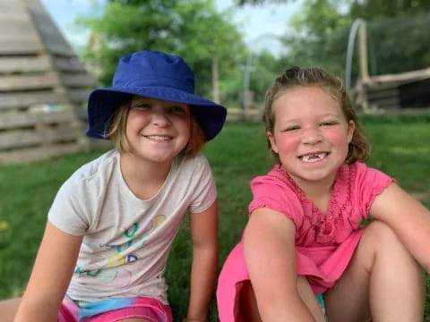 two girls sitting on a bench