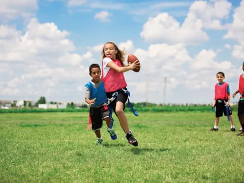 a group of kids playing football