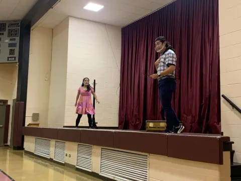 a person and a girl on a stage