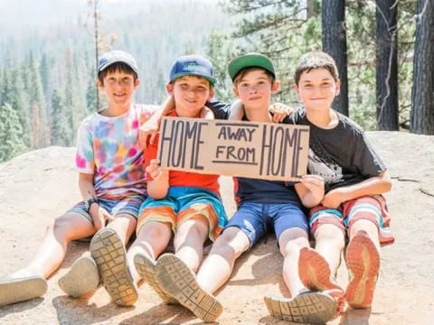 a group of boys holding a sign