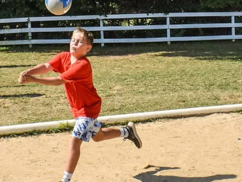 a boy playing with a ball