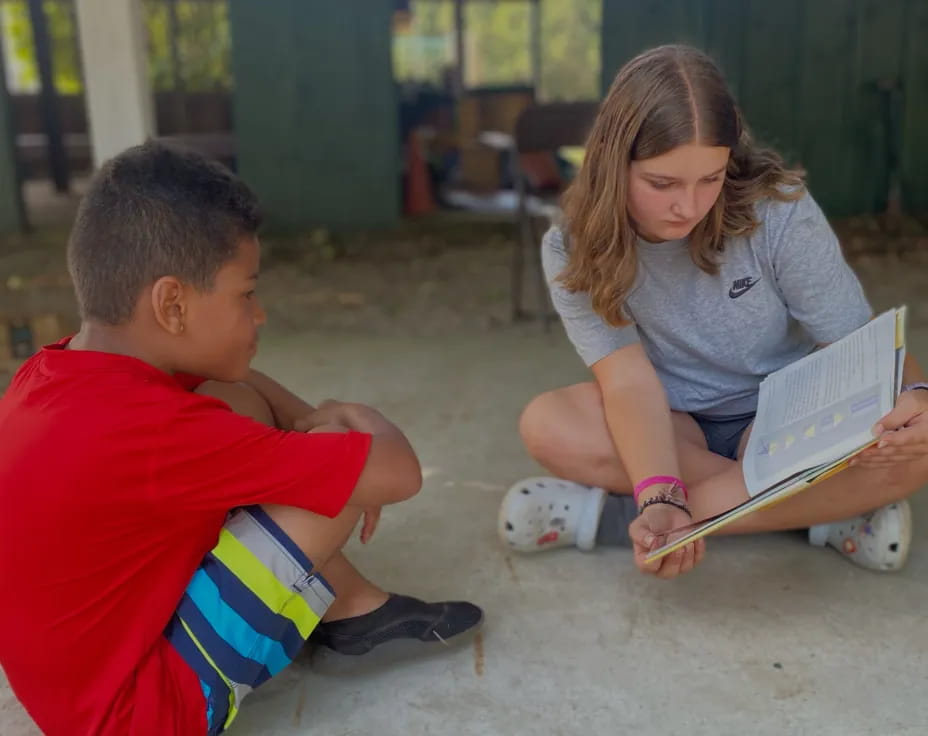 a person and a boy reading a book