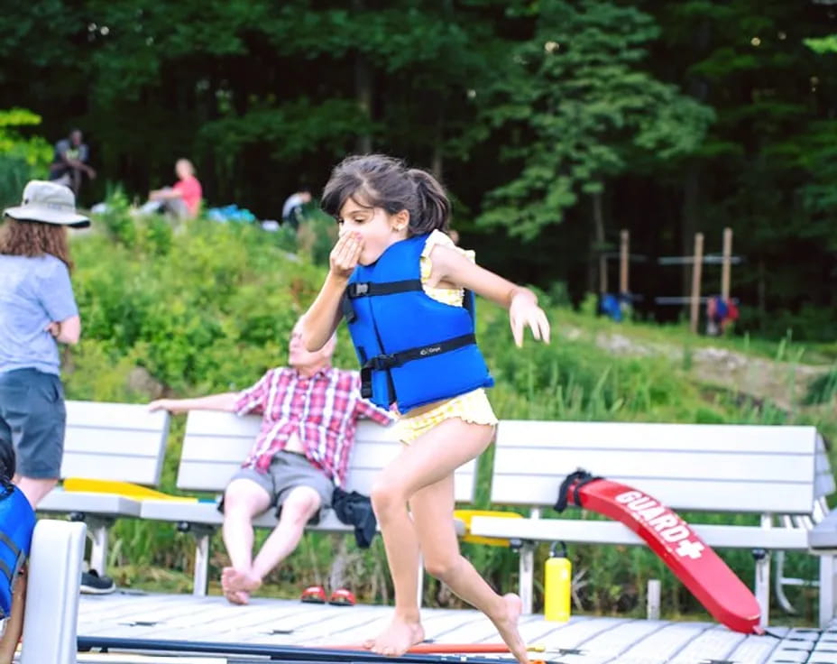 a girl jumping on a bench