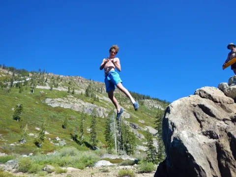 a man jumping off a cliff