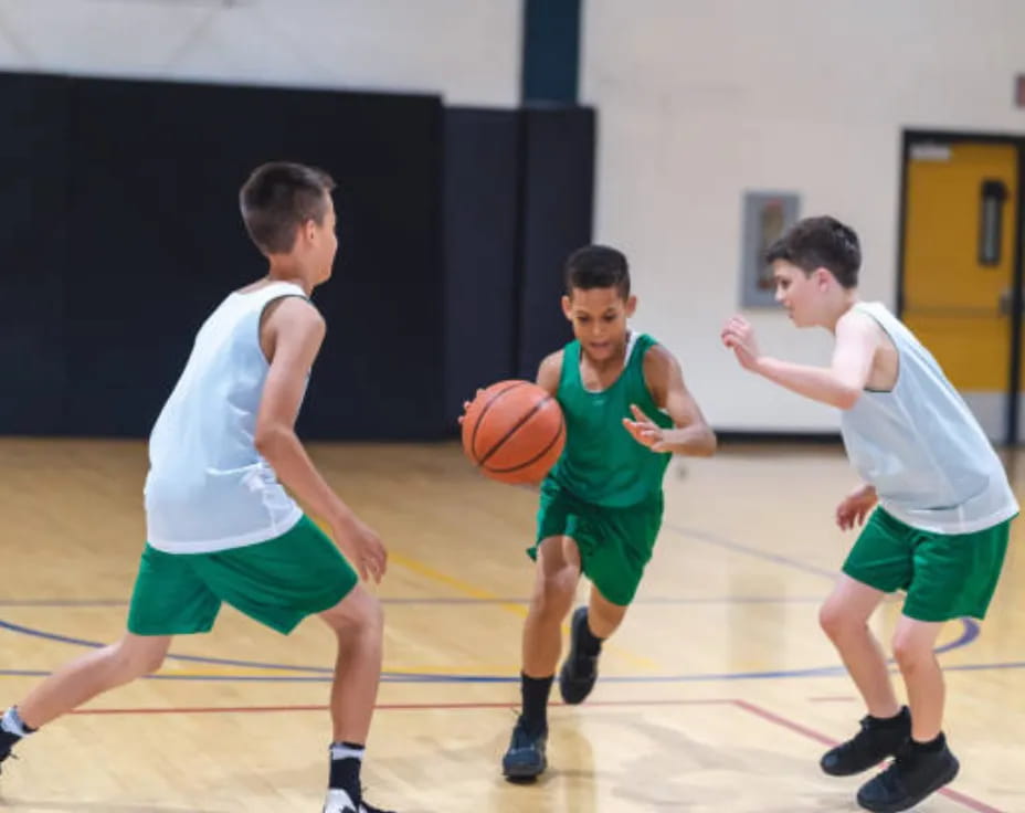 a group of boys playing basketball