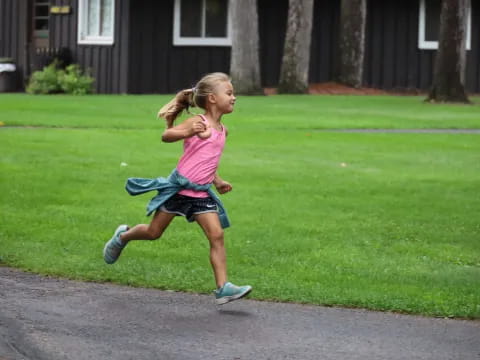 a girl running on a sidewalk