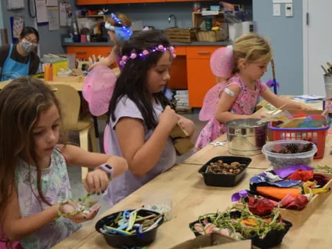 a group of children making food