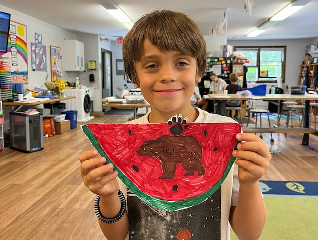 a boy holding a toy