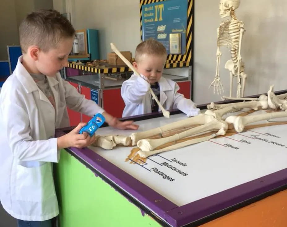 a boy and a boy playing with a toy