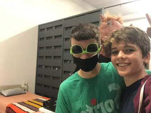 a couple of boys wearing clothing