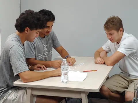 a group of men sitting at a table