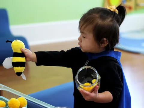 a child holding a yellow duck