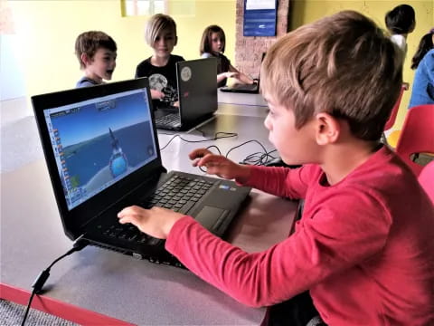 a boy using a laptop