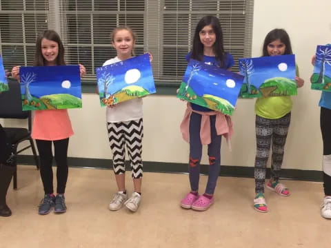 a group of girls holding signs
