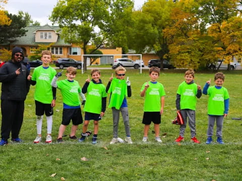 a group of kids in green shirts