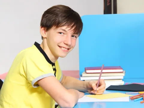 a boy sitting at a desk