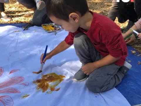 a child painting on the ground