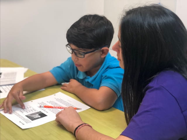 a person and a boy looking at a book