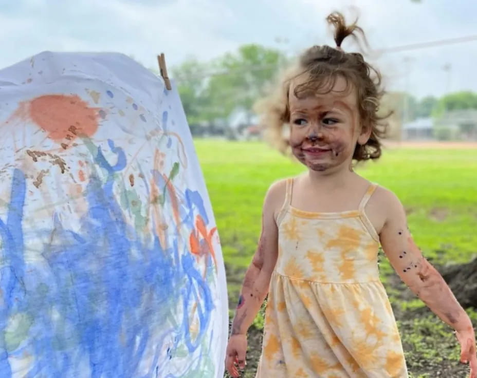 a girl holding a painting