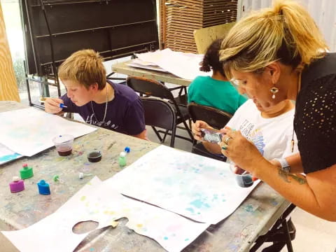 a person and a child painting