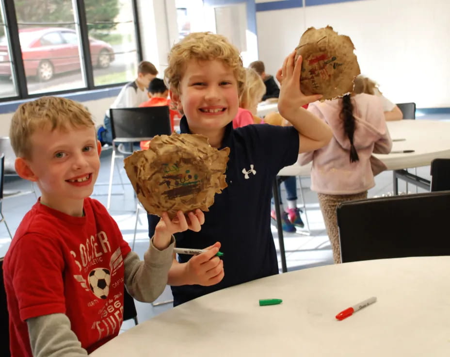 a couple of kids holding a cookie