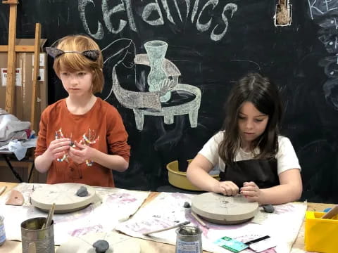 a couple of women painting