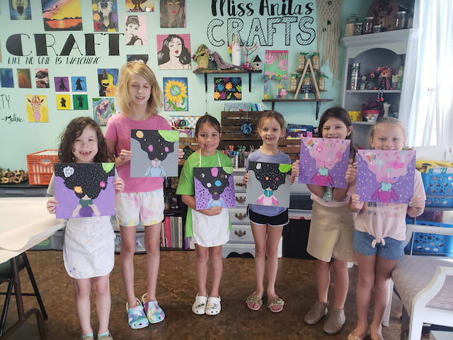 a group of children holding signs