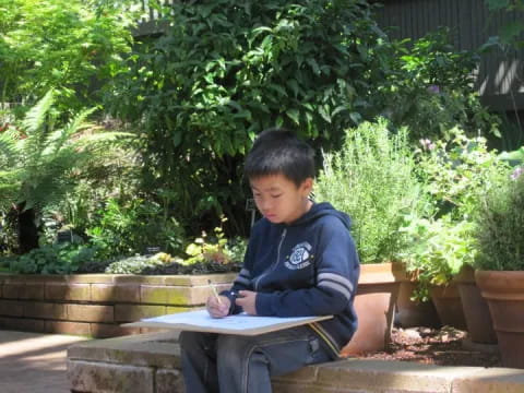a boy sitting on a bench