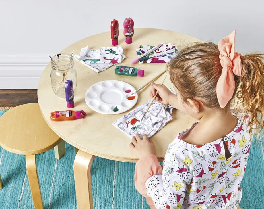 a girl painting on a table
