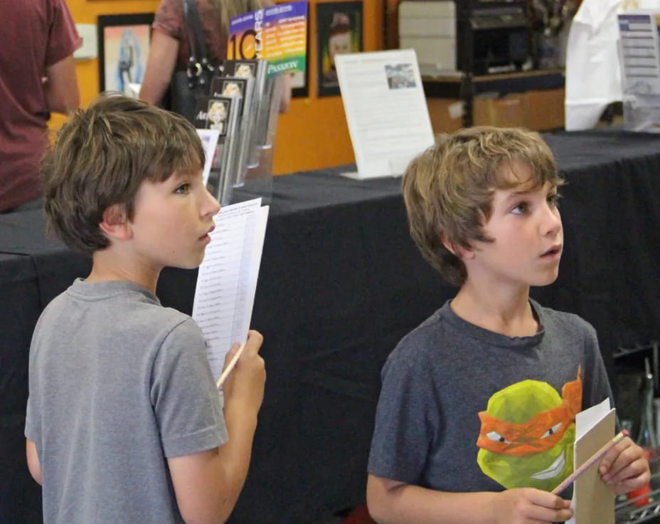a couple of boys holding books
