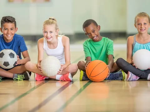 a group of kids holding balls