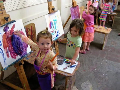 a group of children painting