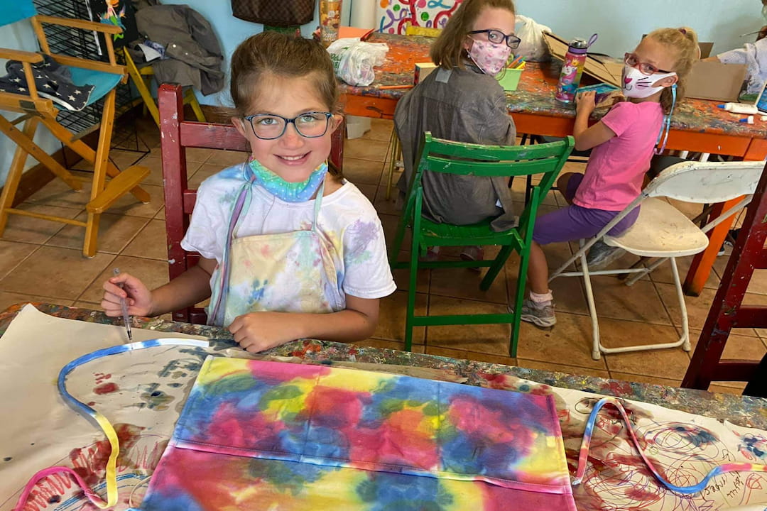 a young girl sitting at a table